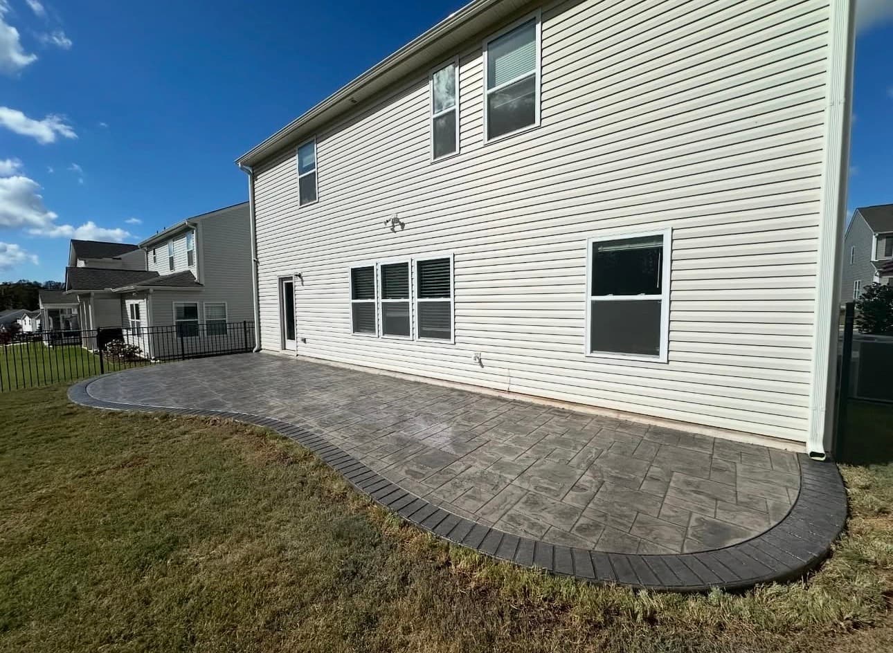Wide backyard patio with pavers